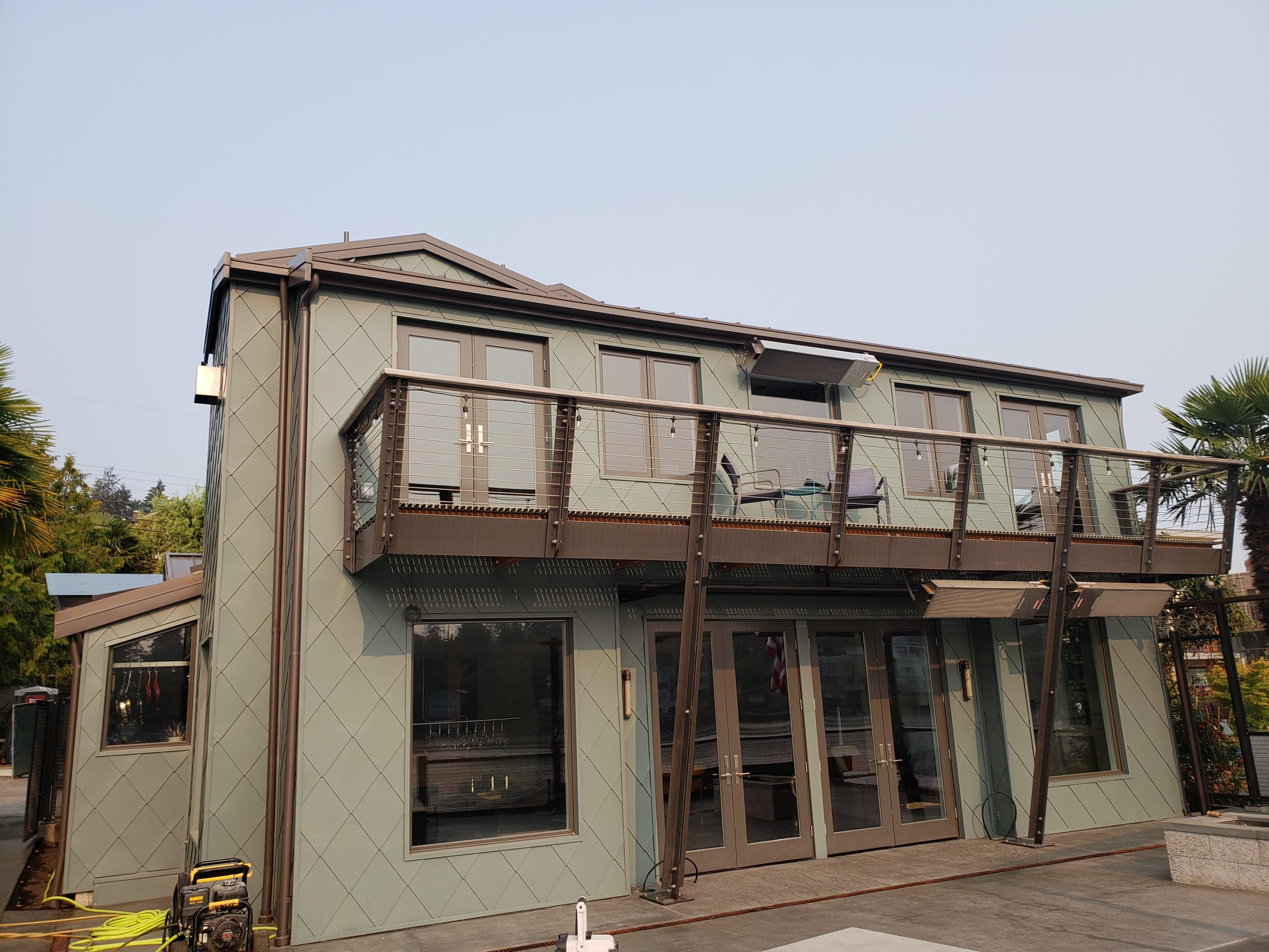Home with metal wall cladding protection from corrosive environment