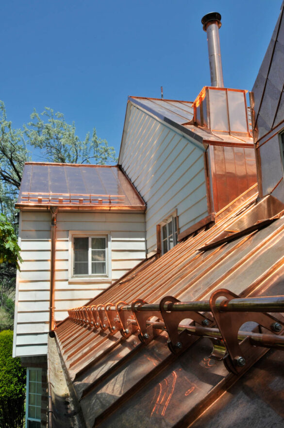 Shiny copper roof with snow hooks installed
