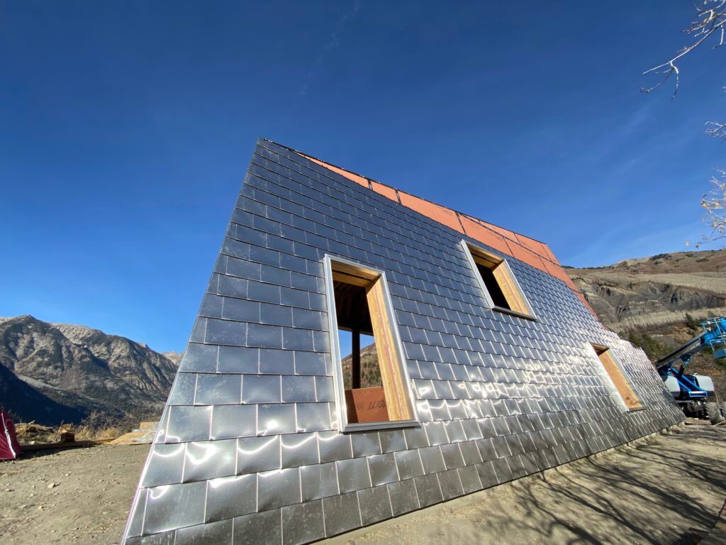 Plumeria shingle on polished stainless steel roof