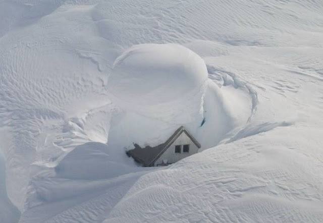 Home surrounded with snow