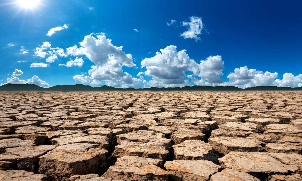 Extreme hot sun beating down on cracked earth