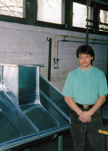 Erno posing nect to sample of metal roof