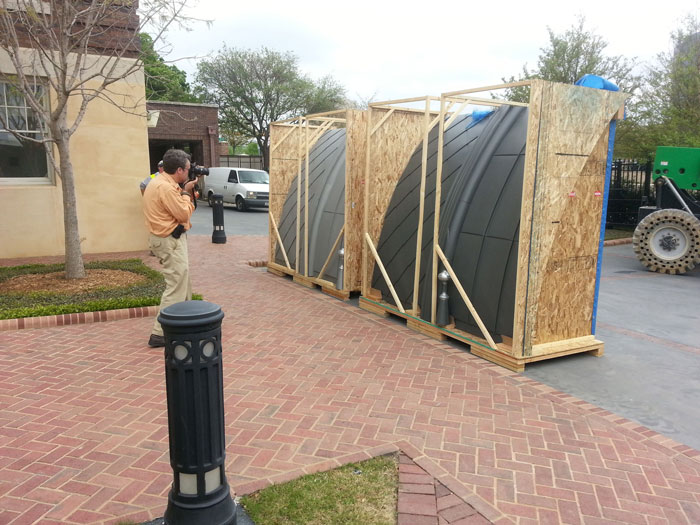 man taking pictures of life size dome samples