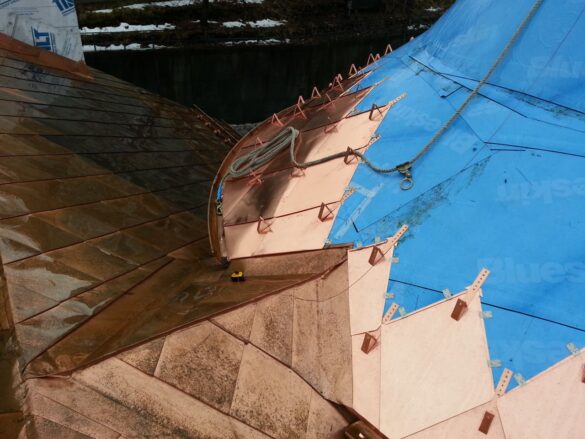partially installed copper roof on a turret with concealed fasteners