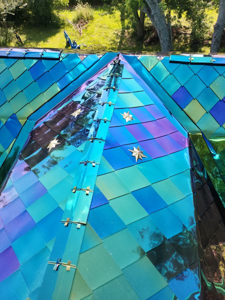 72-degree diamond shingles with chromium oxide "mermaid" iridescent finish, spangled with golden stars, used in roofing and wall cladding.